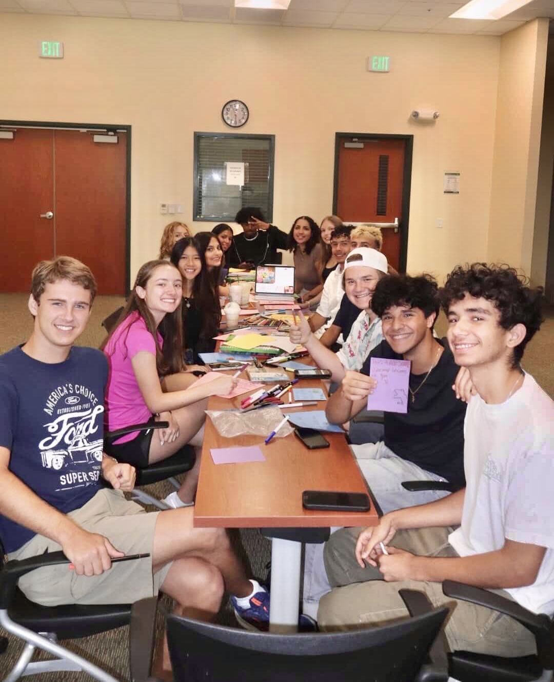 Neuro Kids Now team of youth volunteers gathered around a table making cards